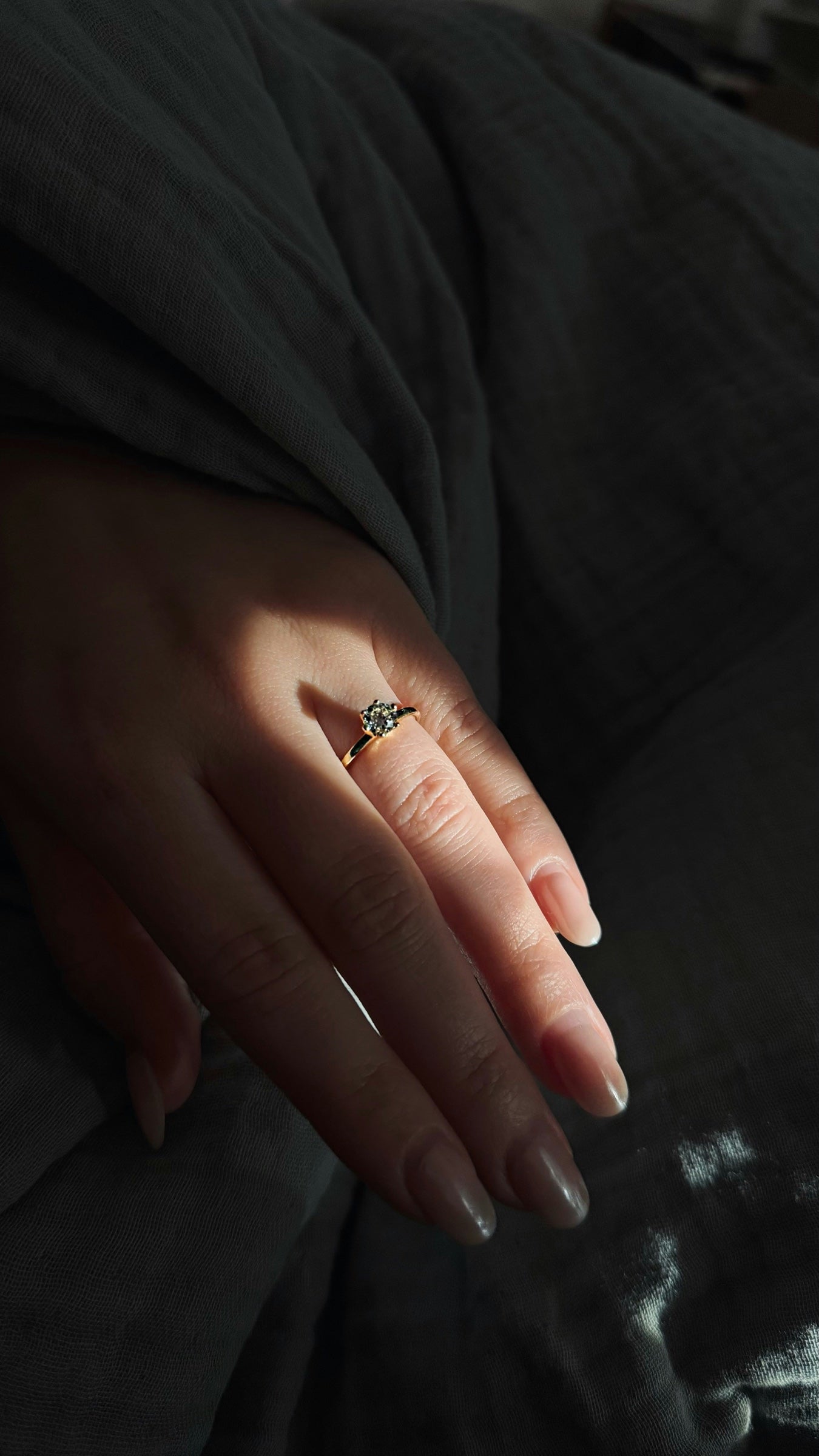 A yellow gold diamond solitaire in soft daylight